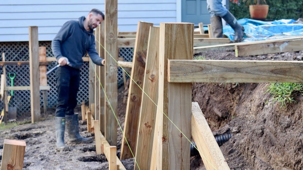 man building a wood retaining wall