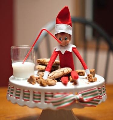 elf drinking milk and eating cookies 