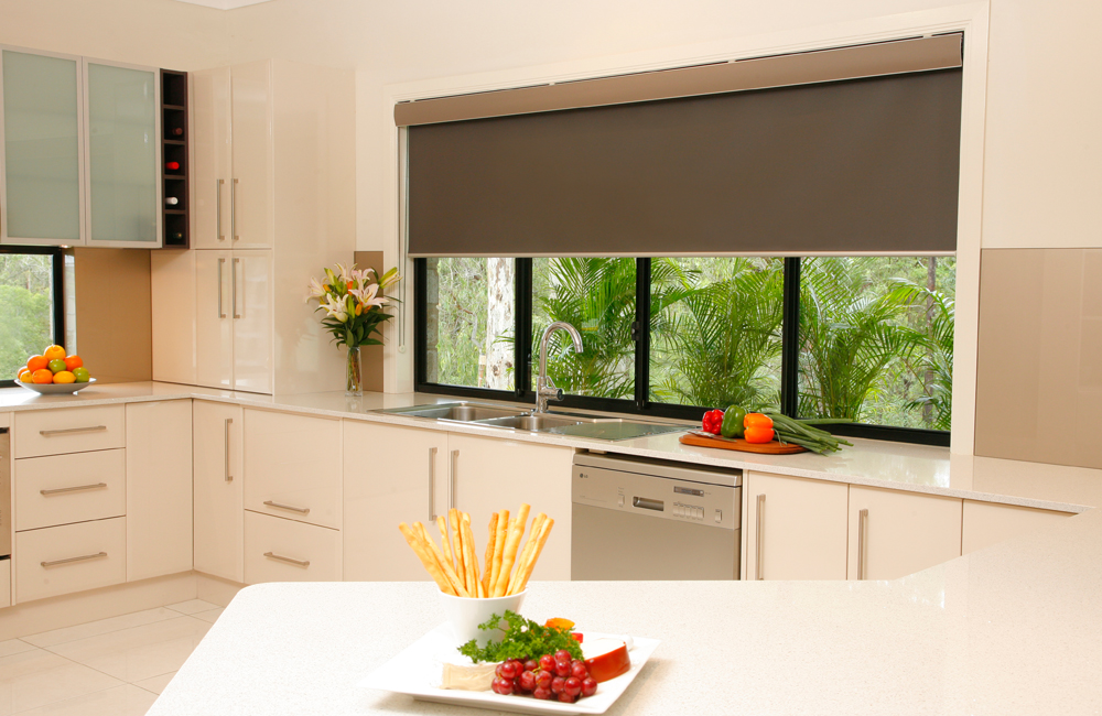 A kitchen with blinds on a window