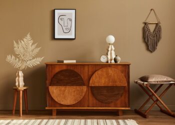 A corner in home decorated with wooden furniture and other decorative items
