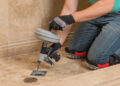 A man trying to unblock a shower drains