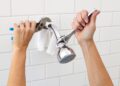 A person replacing a showerhead