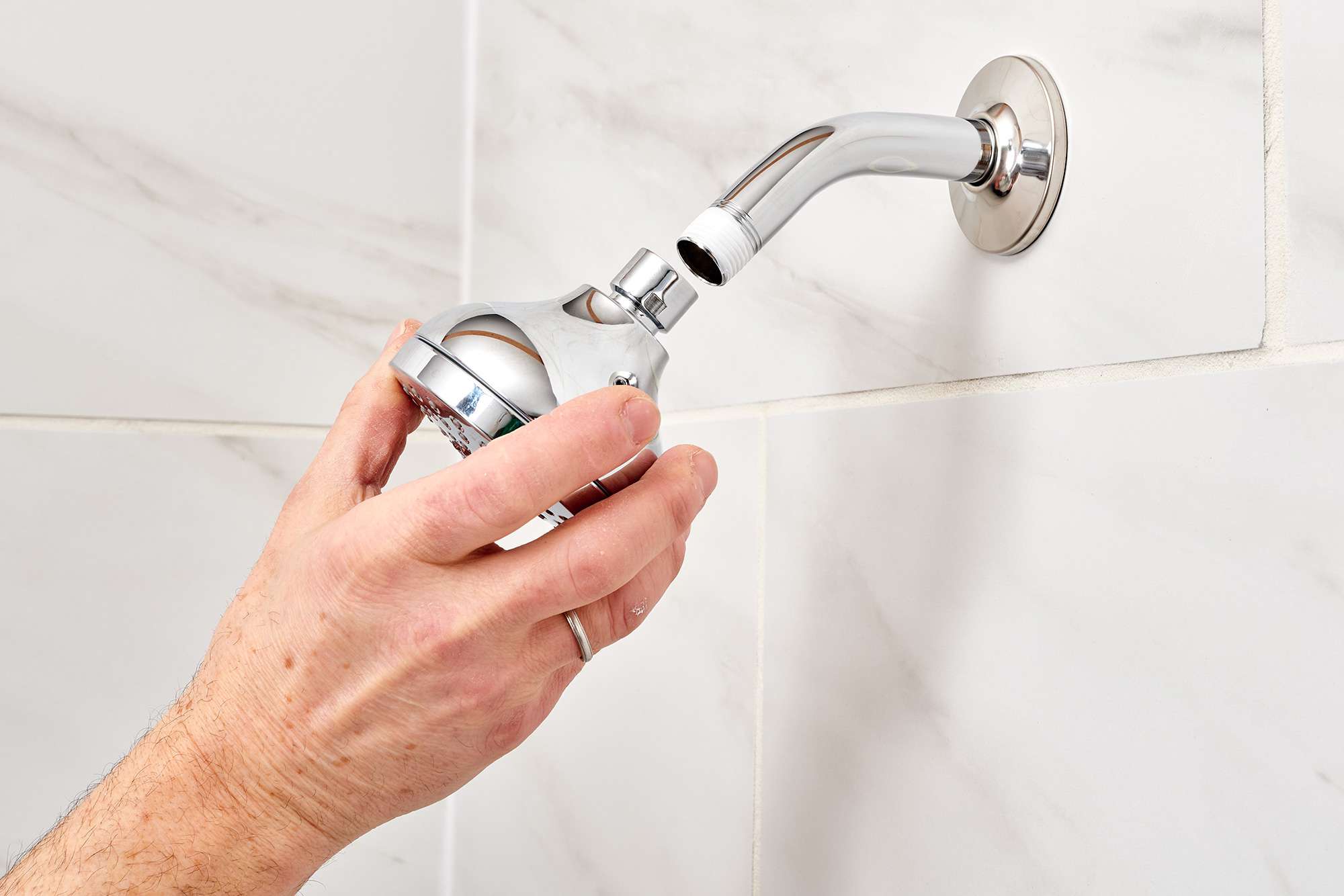 Applying Plumbers Tape to replace a showerhead 