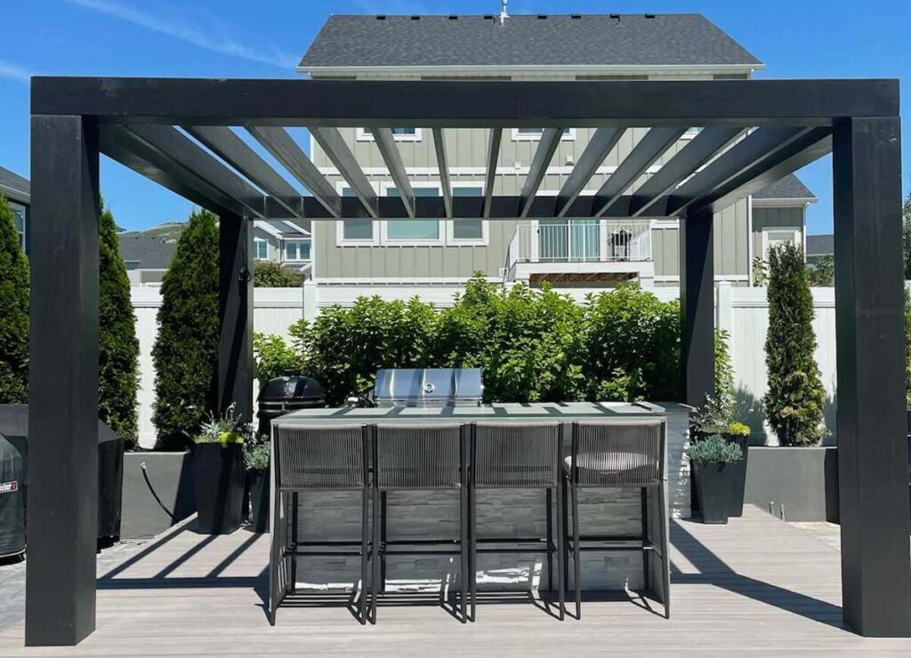 Black pergola outdoor kitchen with metal roof