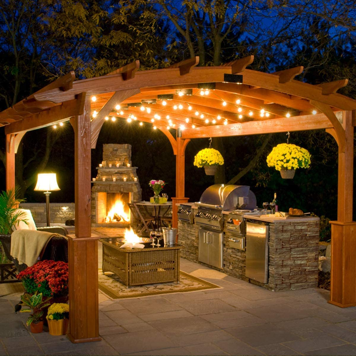 curved pergola, string lights in outdoor kitchen